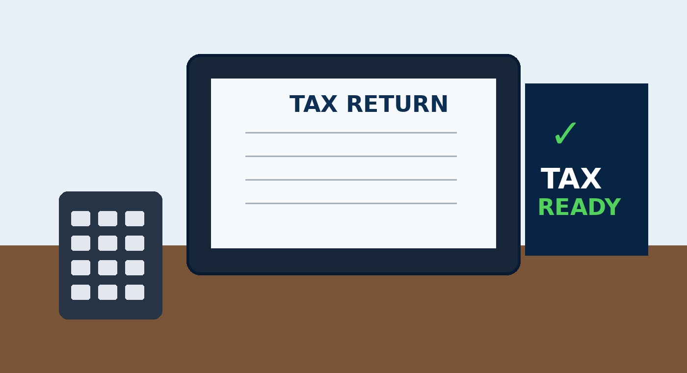 Tax preparation workspace with laptop, calculator, and checklist